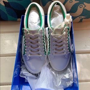 White and Green Torn Burch ruffled sneakers.